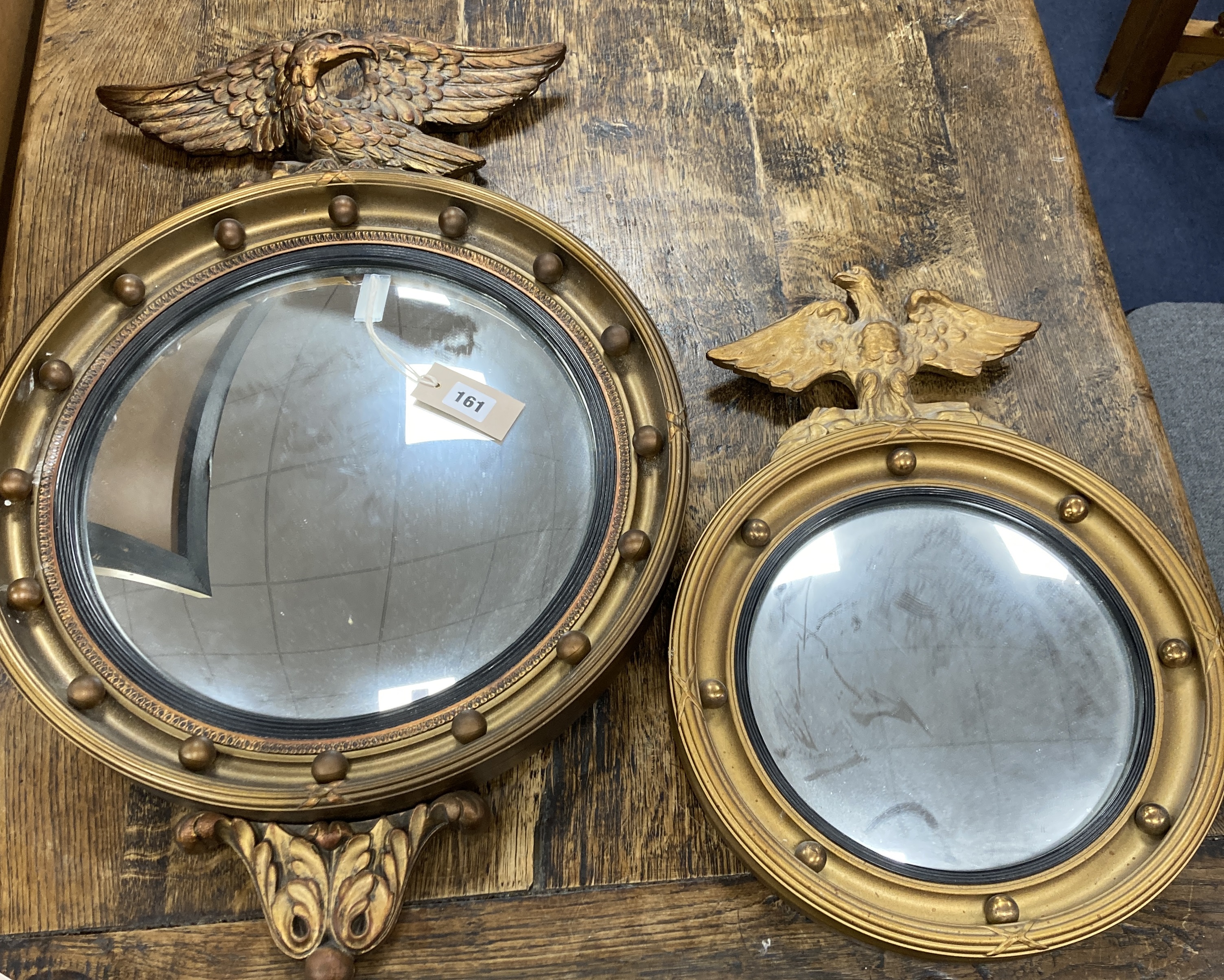 Two Regency style gilt-framed convex mirrors, larger 47cm diameter